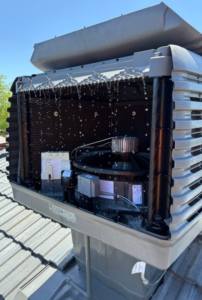 Open evaporative cooling unit with water flowing during a Coolcare service inspection